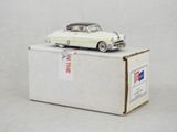une petite voiture blanche posée sur une boîte