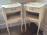 two white tables with drawers on them in a room