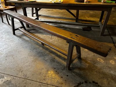 un long banc en bois placé à côté d'une table dans une pièce