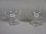 pair of clear glass goblets on a white surface with a price tag