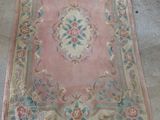 an old rug is being cleaned and cleaned in a garage