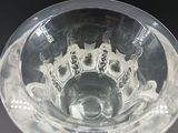 a glass bowl with a design on it on a table