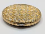 an image of a gold and silver purse on a white surface