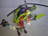 a green helicopter with a man standing next to it
