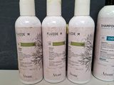 three bottles of sham and lotion sitting on a table