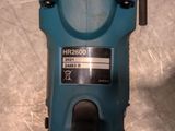 a close up of a blue electric drill on a metal surface