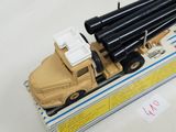 a toy truck with a bunch of black pipes on top of it