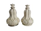 pair of white ceramic salt and pepper shakers on a white background