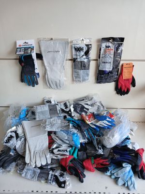 a pile of gloves and gloves sitting on a shelf