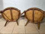 two wooden chairs sitting on top of a tiled floor next to a wall