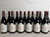 six bottles of wine are lined up on a table