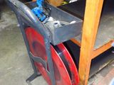 a picture of a red and black chair in a garage