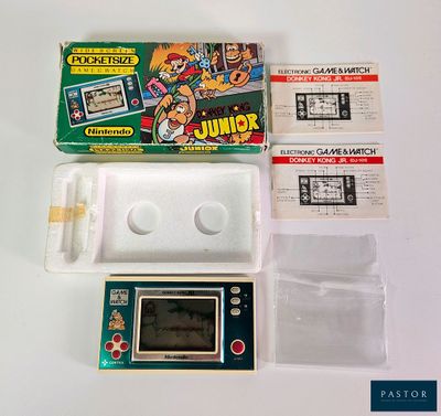 a game console with a game on it next to other items