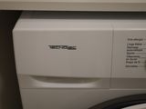 a white washer and a dryer in a small room