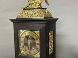 a clock with an angel on top of it on a table