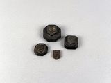 four pieces of metal that are on a white surface