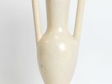 a white vase that is sitting on a white surface