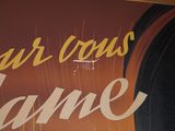 a sign that says four cows flame on the side of a building
