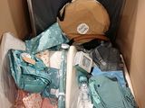 a box filled with clothes and a bag of luggage