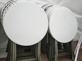 quatre tables blanches et quatre chaises sous une tente