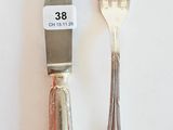 two forks and a knife on a white table