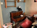 a room with a bed, a desk, a chair, and a shelf