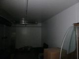 a room with a lot of boxes and a ceiling fan