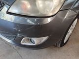 a picture of a car that has been dented and is parked in a garage