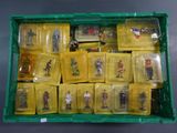 a green box filled with plastic figurines of soldiers