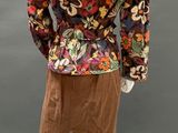 a mannequin wearing a floral jacket and brown shorts