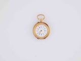 an old gold pocket watch with a white face on a white background