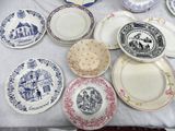 many plates on a table with blue and white designs on them