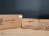 two boxes sitting on top of a table next to each other