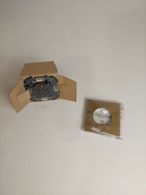 a cardboard box with a camera attached to it next to a cardboard box with a camera attached to it