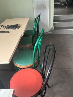 four chairs sitting at a table in a small room