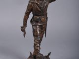pair of bronze figurines of a man and a dog