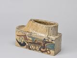 a small wooden box with a painting on it