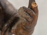 a close up of a statue of a hand holding a piece of wood