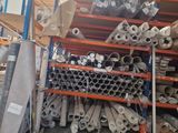 many rolls of fabric on the shelves in the warehouse