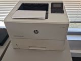 a white printer sitting on top of a desk next to a window