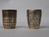 four different types of silver vases sitting on a white surface