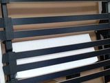 a black and white bench in a box with a red stripe
