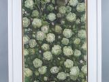 an oil painting of white flowers in a white frame on a gray background