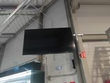 a television that is hanging from the ceiling in the room