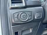 the interior of a car with a steering control and dashboard controls