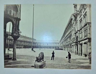 a black and white photo of a man and a woman in a courtyard