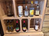 a wooden shelf with bottles of alcohol on it