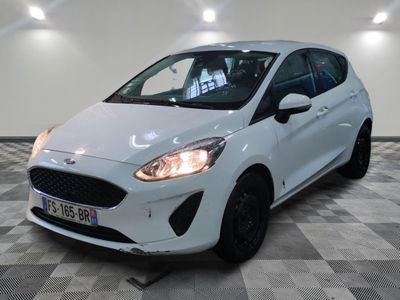 the white ford fiesta is parked in a room with a checkered floor