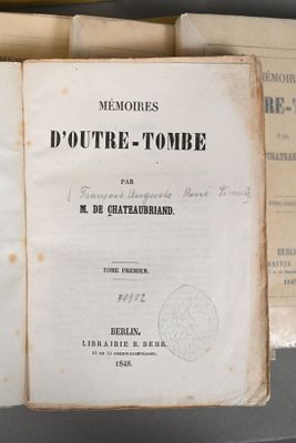 several old books are stacked on top of each other on a table