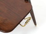 a small wooden table with a bird design on it